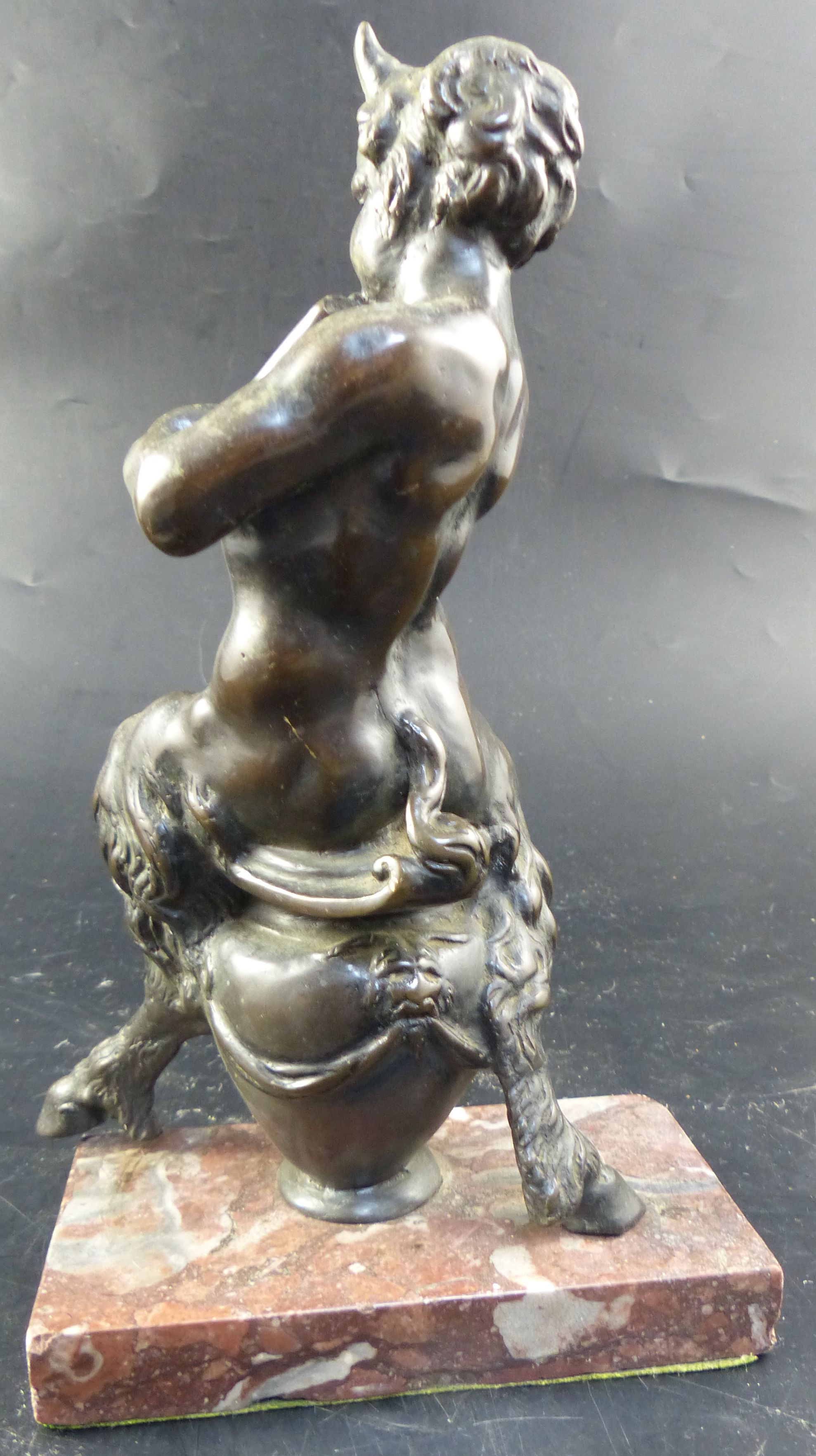 After Frederick Pomeroy (1856-1924). A 19th century Italian bronze model of a satyr playing pan pipes, overall height 24.5cm.